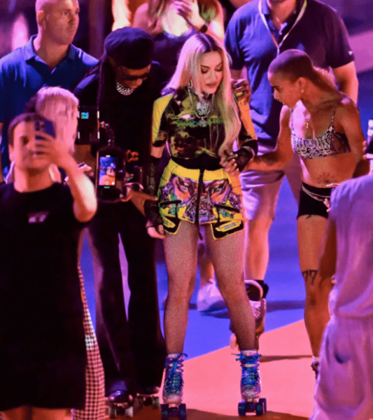 madonna-skates-on-a-rollerblade-while-surrounded-by-people-to-avoid-falling